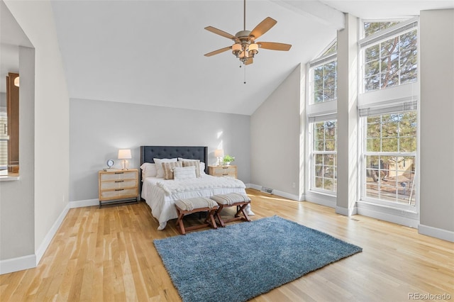 bedroom with beam ceiling, ceiling fan, high vaulted ceiling, and light hardwood / wood-style floors