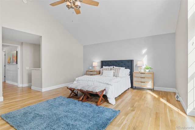 bedroom with hardwood / wood-style flooring, high vaulted ceiling, and ceiling fan