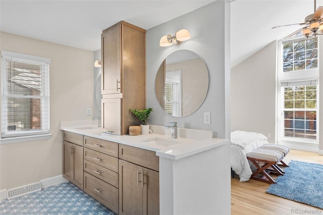 bathroom featuring hardwood / wood-style flooring, vanity, and ceiling fan