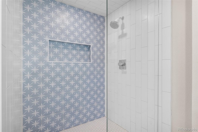 bathroom with tiled shower