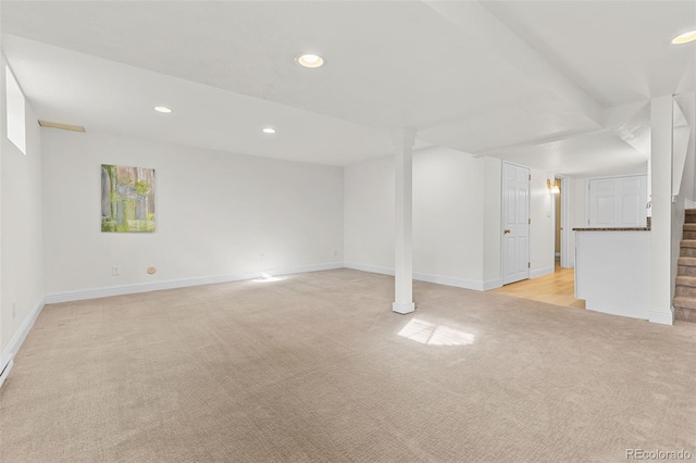 basement featuring light carpet