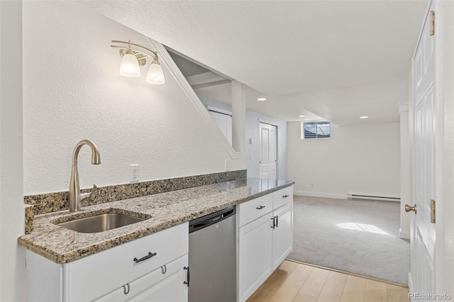 kitchen with sink, white cabinetry, baseboard heating, dishwasher, and light stone countertops