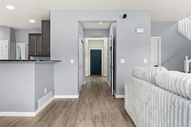 interior space featuring light wood-type flooring, baseboards, and visible vents