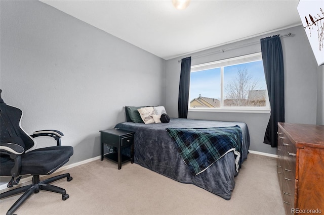 bedroom with baseboards, lofted ceiling, and carpet floors