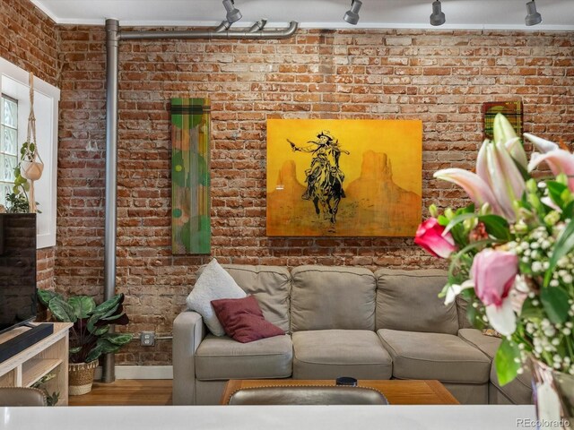 2524 Champa St Unit 1, Denver, CO 80205 - living room featuring brick wall and wood finished floors