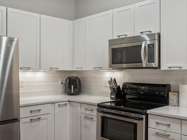 2524 Champa St Unit 1, Denver, CO 80205 - kitchen with appliances with stainless steel finishes, white cabinets, light countertops, and tasteful backsplash