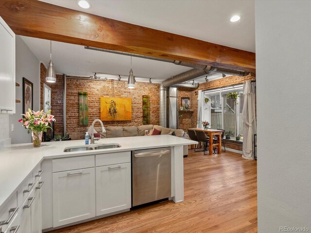 2524 Champa St Unit 1, Denver, CO 80205 - kitchen featuring dishwasher, a sink, brick wall, light wood-style flooring, and open floor plan