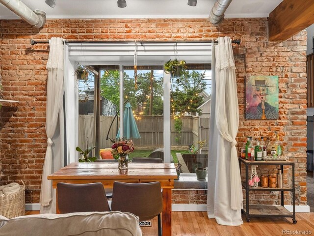 2524 Champa St Unit 1, Denver, CO 80205 - dining area with brick wall and wood finished floors