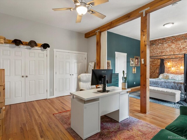 2524 Champa St Unit 1, Denver, CO 80205 - office area with ceiling fan, light wood-style flooring, brick wall, and baseboards