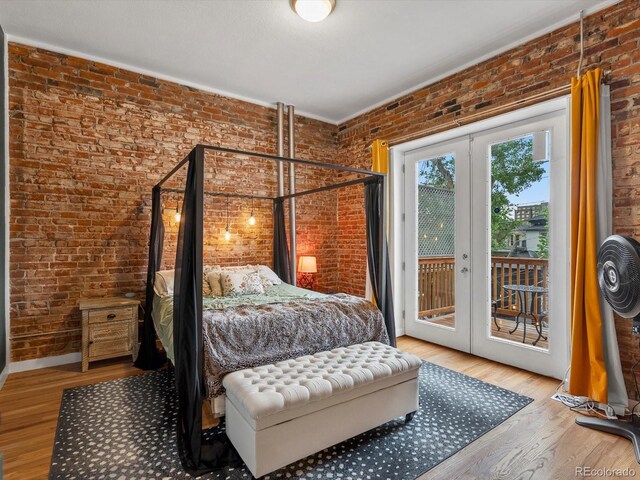 2524 Champa St Unit 1, Denver, CO 80205 - bedroom with brick wall, french doors, access to outside, and wood finished floors