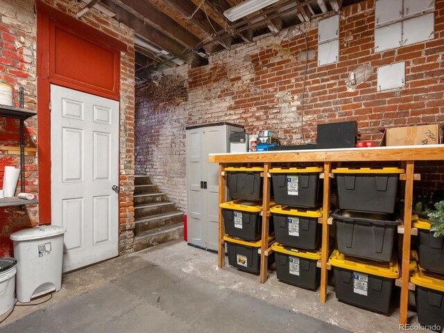 2524 Champa St Unit 1, Denver, CO 80205 - unfinished below grade area featuring brick wall and stairs