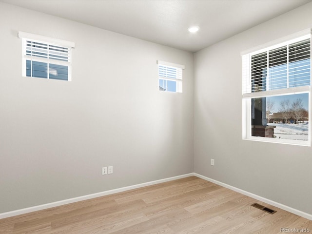 spare room with light hardwood / wood-style flooring