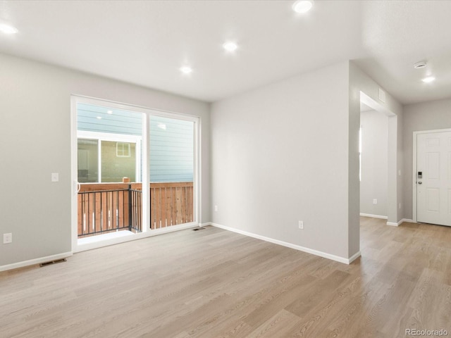 spare room with light hardwood / wood-style flooring