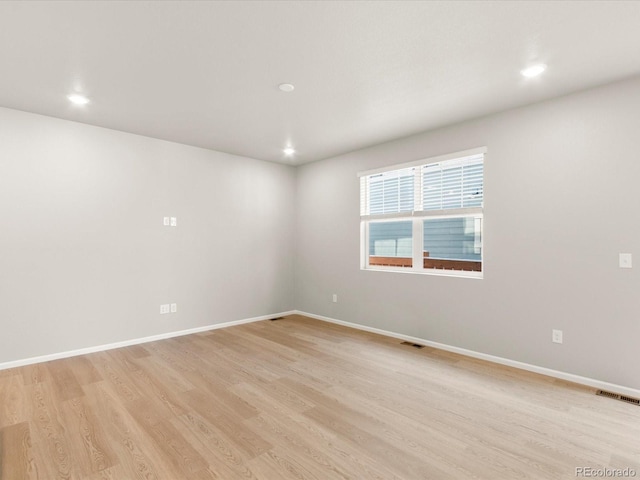 spare room with light hardwood / wood-style flooring