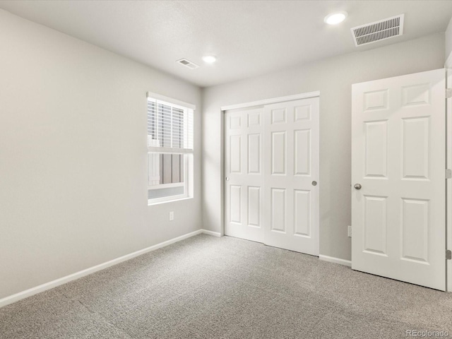 unfurnished bedroom featuring carpet floors and a closet