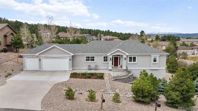 ranch-style home with driveway, a garage, stucco siding, and a residential view