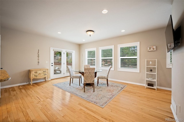 dining room with light wood finished floors, baseboards, and recessed lighting