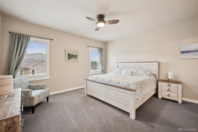 bedroom featuring dark colored carpet, multiple windows, baseboards, and a ceiling fan