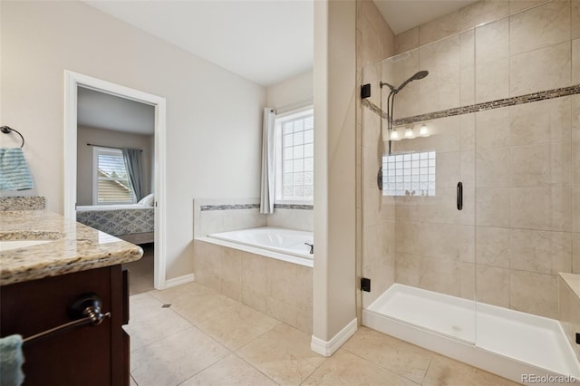 bathroom with a stall shower, connected bathroom, vanity, a bath, and tile patterned flooring