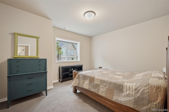 carpeted bedroom with baseboards