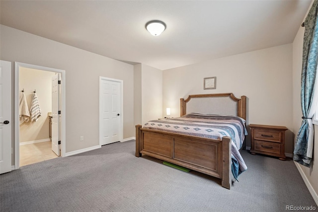 bedroom featuring carpet floors, baseboards, and ensuite bath