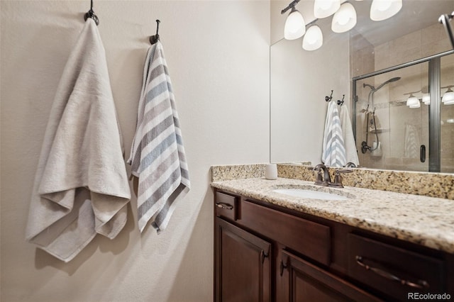 bathroom featuring a stall shower and vanity