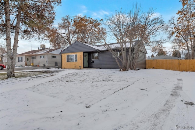 view of snow covered rear of property