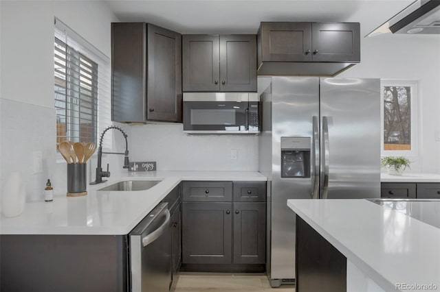 kitchen featuring dark brown cabinets, sink, and appliances with stainless steel finishes