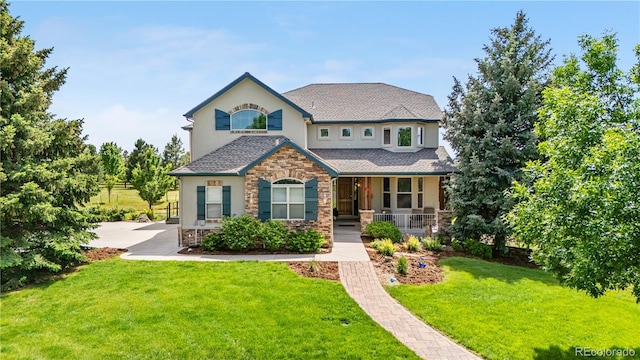 12665 S Robinson Ranch Ct, Parker, CO 80134 - view of front facade with stone siding, covered porch, stucco siding, a front lawn, and driveway