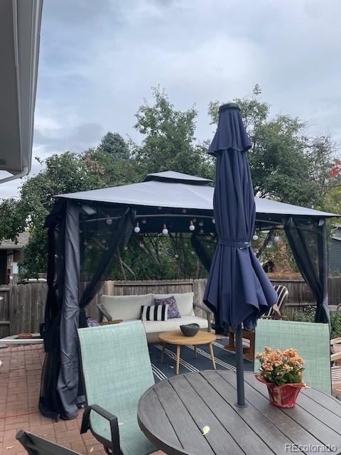 wooden terrace featuring a gazebo