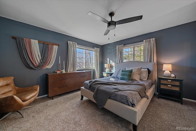 bedroom featuring multiple windows, ceiling fan, and carpet