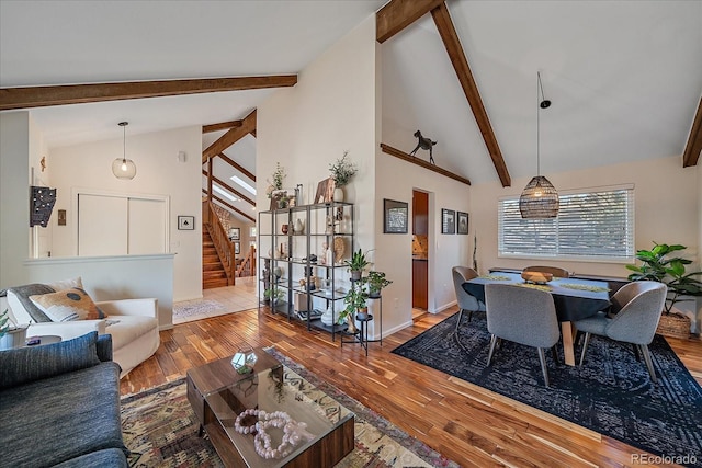 living room featuring hardwood / wood-style flooring, high vaulted ceiling, and beamed ceiling