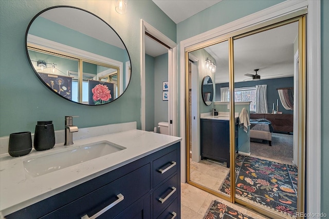 bathroom with vanity, ceiling fan, and toilet