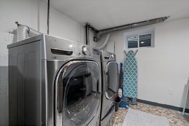 washroom with washing machine and clothes dryer