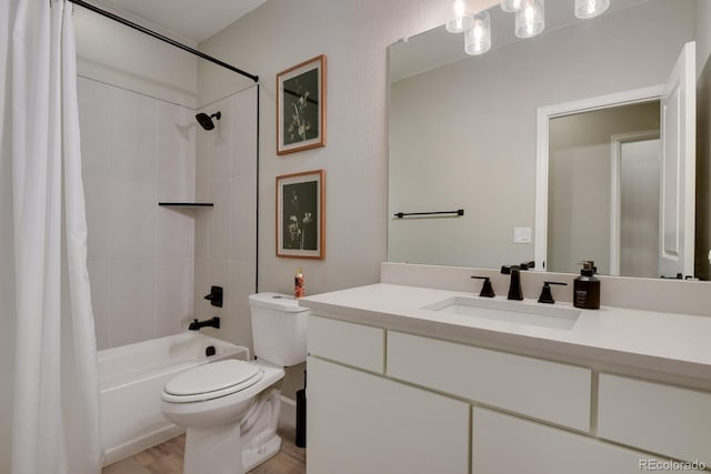 full bathroom featuring vanity, hardwood / wood-style floors, toilet, and shower / bath combo