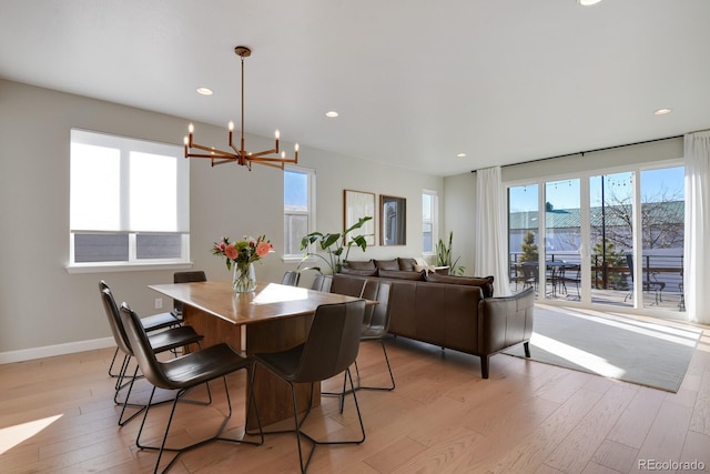 dining room with an inviting chandelier, baseboards, recessed lighting, and light wood-style flooring