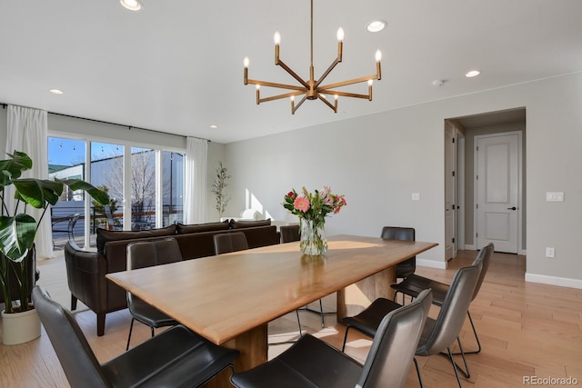dining area with light wood-style floors, recessed lighting, baseboards, and a notable chandelier