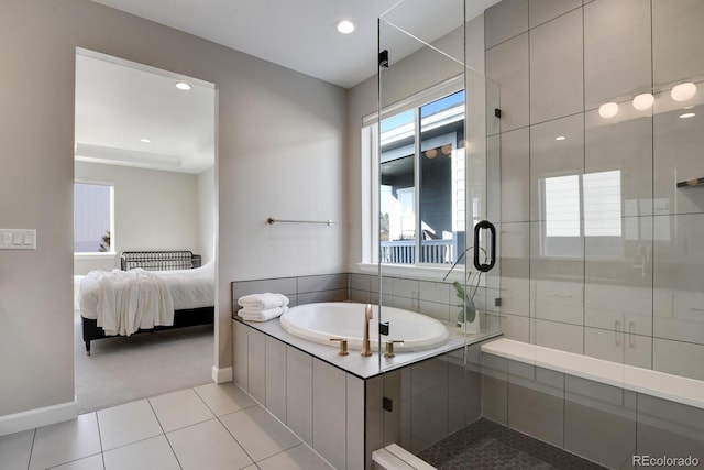 full bathroom featuring a garden tub, a stall shower, tile patterned floors, baseboards, and connected bathroom
