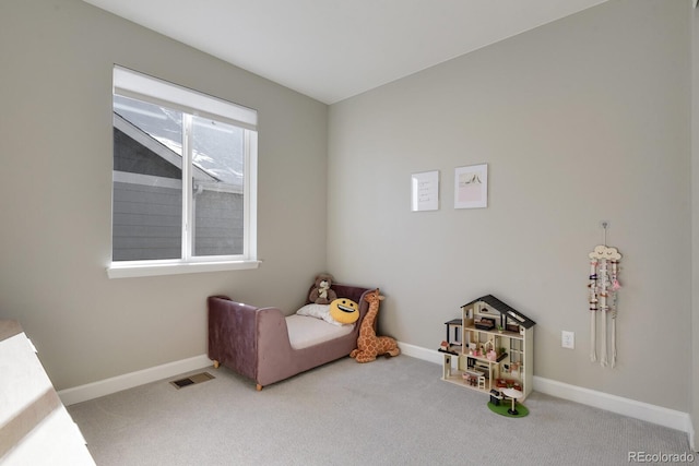 carpeted bedroom featuring baseboards and visible vents