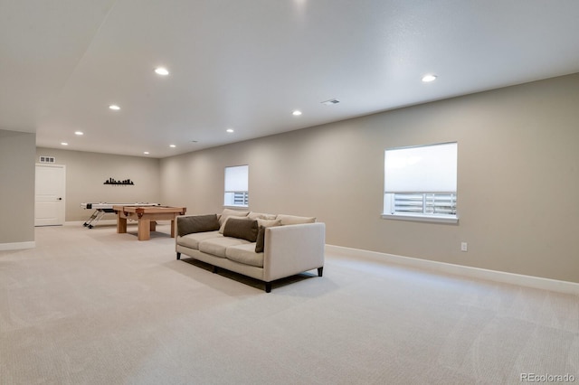 living room featuring light carpet and recessed lighting