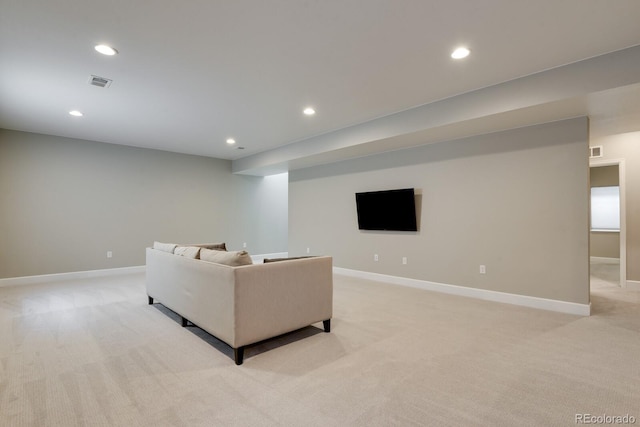 living area with recessed lighting, baseboards, and light colored carpet