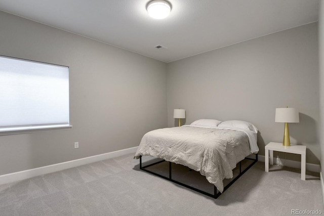 bedroom with baseboards, visible vents, and light colored carpet