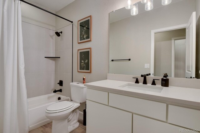 bathroom with vanity, shower / tub combo with curtain, wood finished floors, and toilet