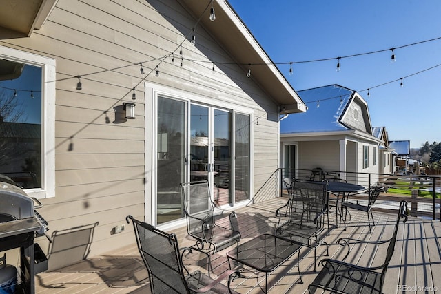 deck with area for grilling and outdoor dining space