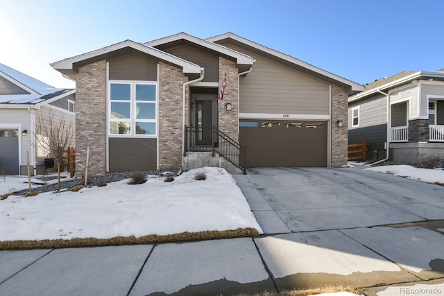 view of front of house with brick siding, a garage, and concrete driveway