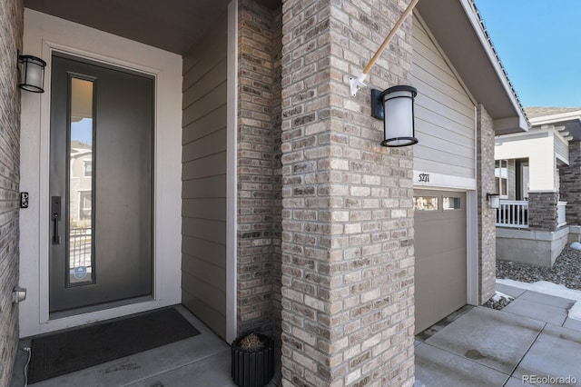 property entrance featuring brick siding
