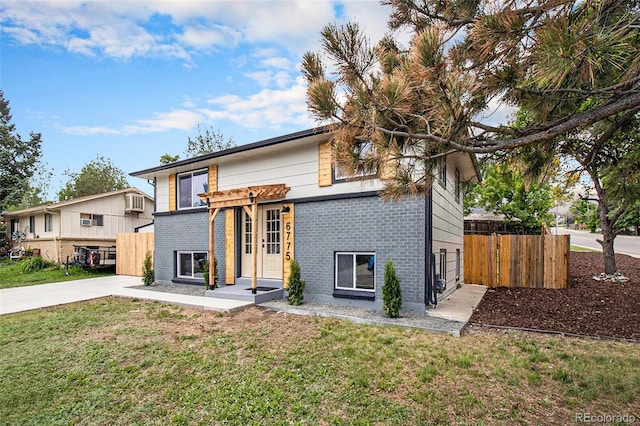 6775 Newland St, Arvada, CO 80003 - view of front facade with brick siding and driveway