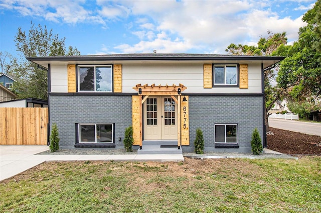 6775 Newland St, Arvada, CO 80003 - view of front of home featuring brick siding and french doors
