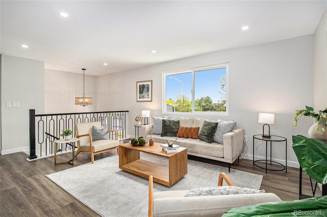 6775 Newland St, Arvada, CO 80003 - living area featuring a chandelier, wood finished floors, baseboards, and recessed lighting