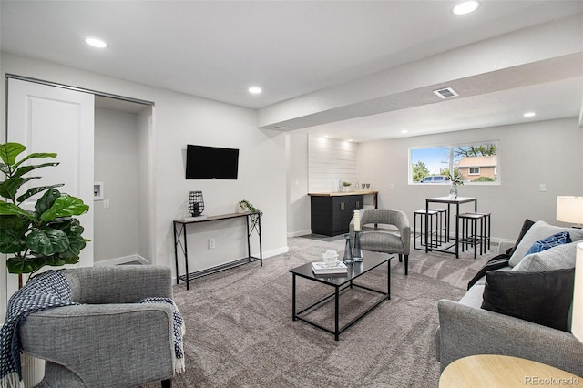 6775 Newland St, Arvada, CO 80003 - living room featuring light carpet, recessed lighting, baseboards, and bar area